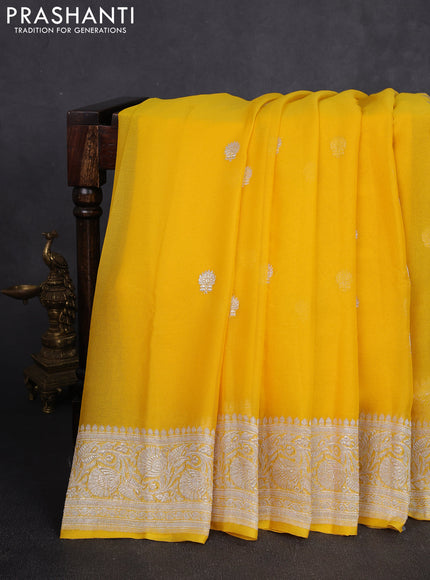 Banarasi chiffon saree yellow with allover silver zari woven buttas and silver zari woven floral border
