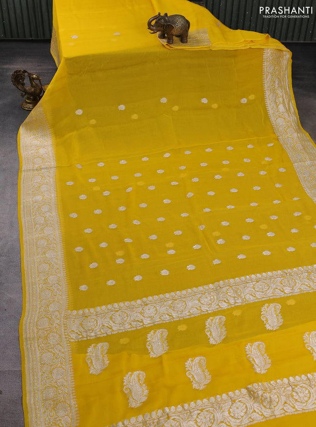 Banarasi chiffon saree yellow with allover silver zari woven buttas and silver zari woven floral border