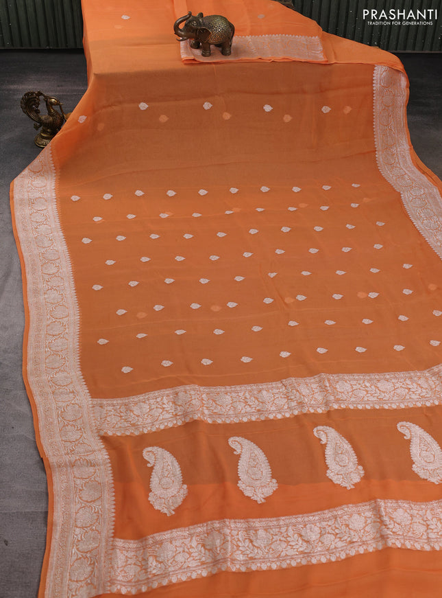 Banarasi chiffon saree light orange with allover silver zari woven buttas and silver zari woven floral border