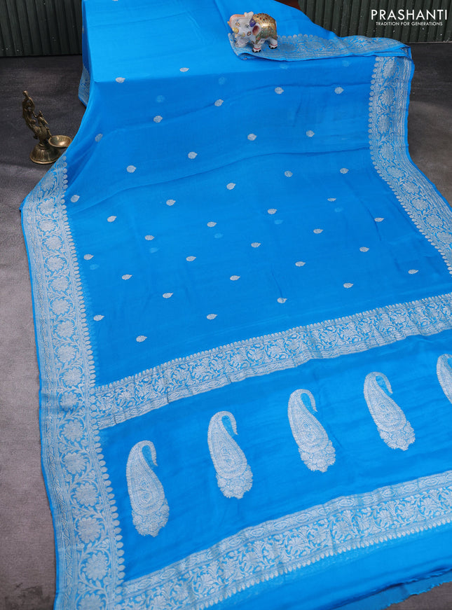Banarasi chiffon saree cs blue with allover silver zari woven buttas and silver zari woven floral border