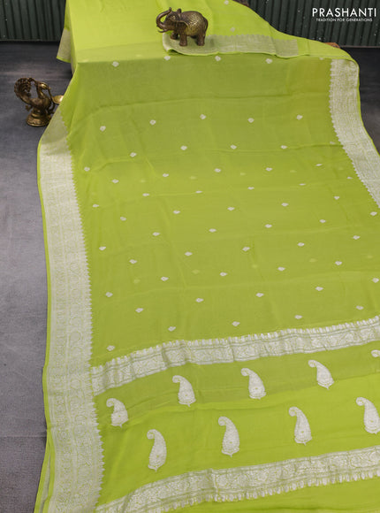 Banarasi chiffon saree lime green with allover silver zari woven buttas and silver zari woven floral border