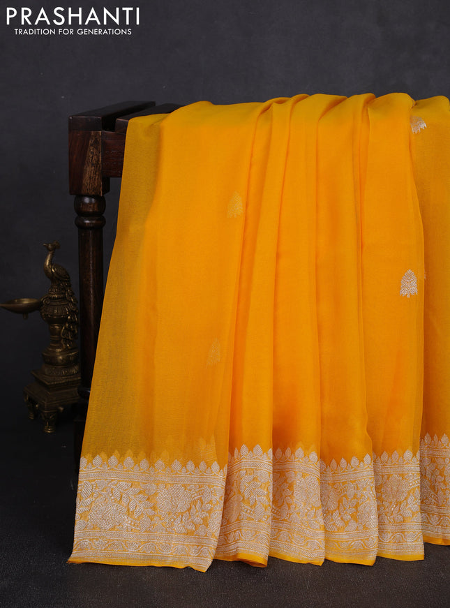 Banarasi chiffon saree yellow shade with allover silver zari woven buttas and silver zari woven floral border