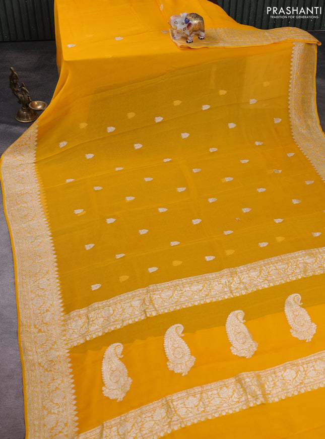 Banarasi chiffon saree yellow shade with allover silver zari woven buttas and silver zari woven floral border