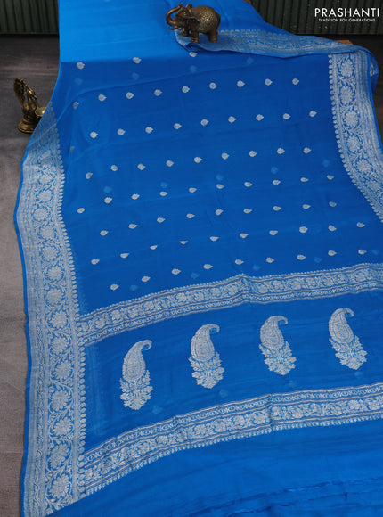 Banarasi chiffon saree cs blue with allover silver zari woven buttas and silver zari woven floral border