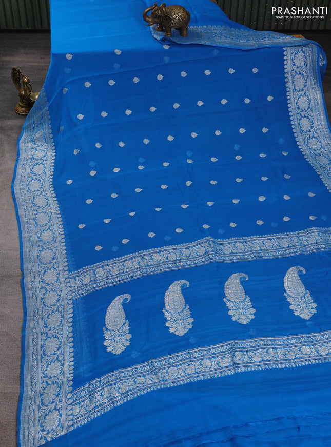 Banarasi chiffon saree cs blue with allover silver zari woven buttas and silver zari woven floral border