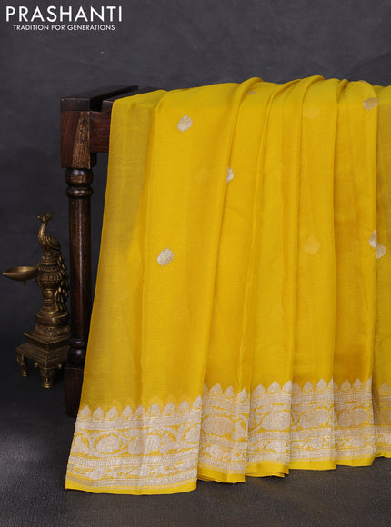 Banarasi chiffon saree yellow shade with allover silver zari woven buttas and silver zari woven floral border