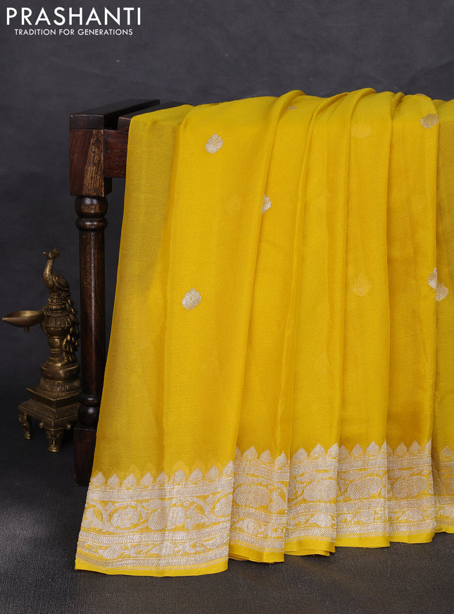 Banarasi chiffon saree yellow shade with allover silver zari woven buttas and silver zari woven floral border