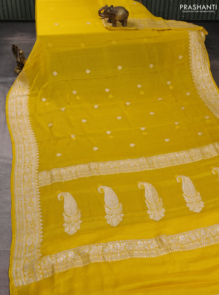 Banarasi chiffon saree yellow shade with allover silver zari woven buttas and silver zari woven floral border