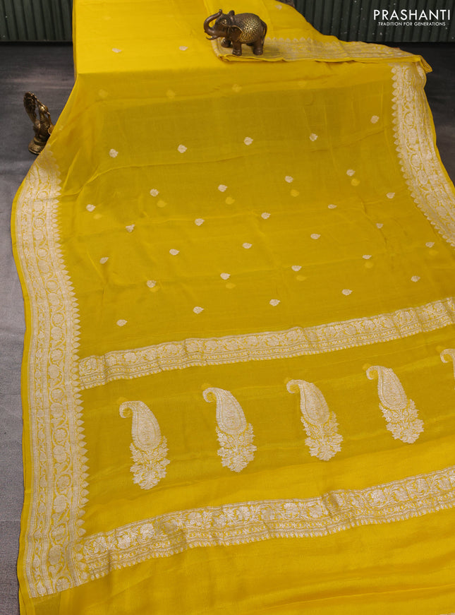 Banarasi chiffon saree yellow shade with allover silver zari woven buttas and silver zari woven floral border