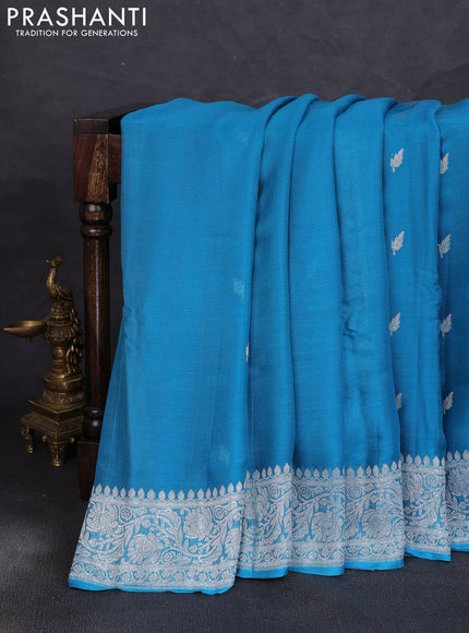 Banarasi chiffon saree teal blue with allover silver zari woven buttas and silver zari woven floral border