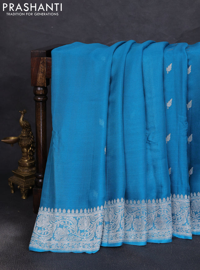 Banarasi chiffon saree teal blue with allover silver zari woven buttas and silver zari woven floral border
