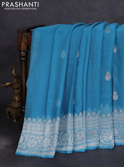 Banarasi chiffon saree blue shade with allover silver zari woven buttas and silver zari woven floral border