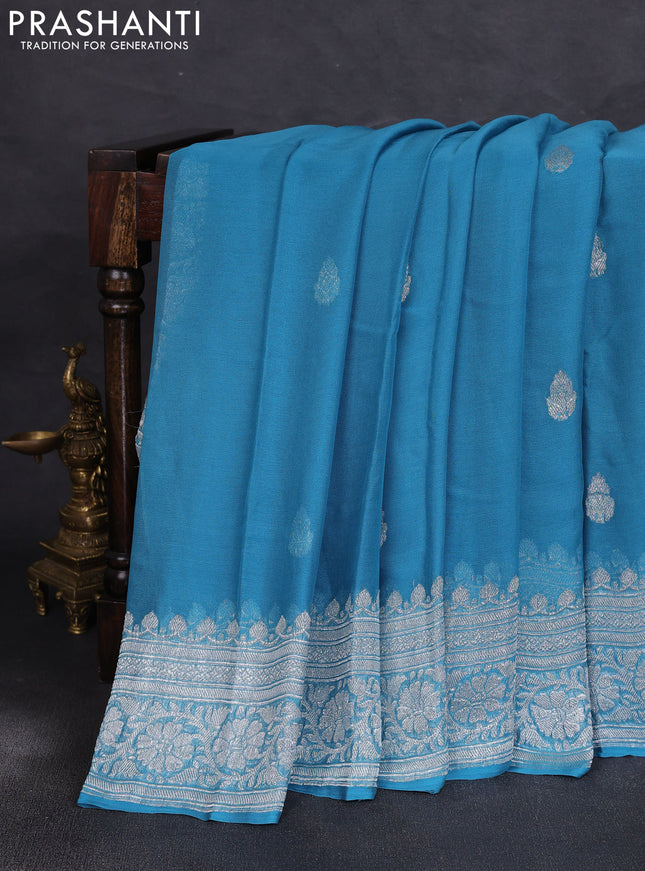 Banarasi chiffon saree blue shade with allover silver zari woven buttas and silver zari woven floral border