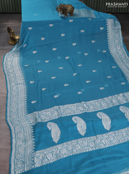 Banarasi chiffon saree blue shade with allover silver zari woven buttas and silver zari woven floral border