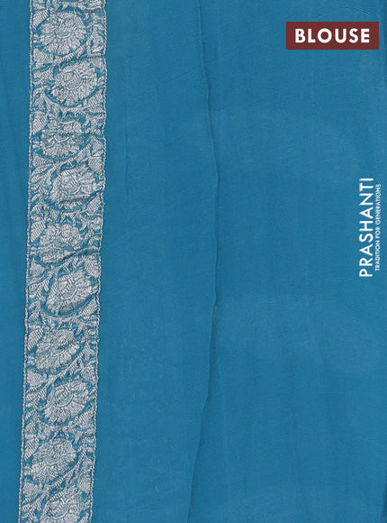Banarasi chiffon saree blue shade with allover silver zari woven buttas and silver zari woven floral border