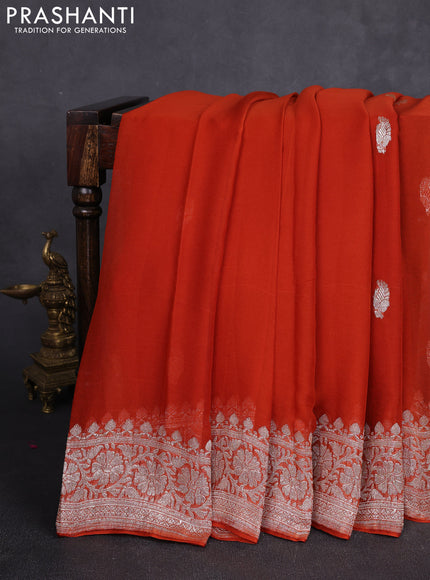 Banarasi chiffon saree rustic orange with allover silver zari woven buttas and silver zari woven floral border