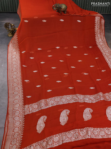 Banarasi chiffon saree rustic orange with allover silver zari woven buttas and silver zari woven floral border