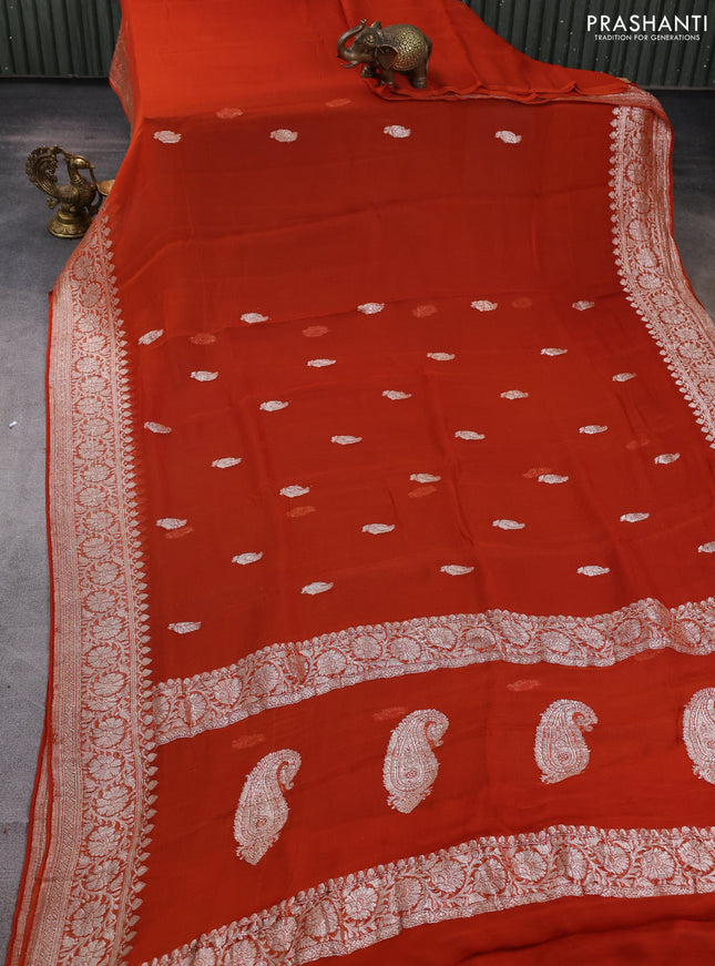 Banarasi chiffon saree rustic orange with allover silver zari woven buttas and silver zari woven floral border
