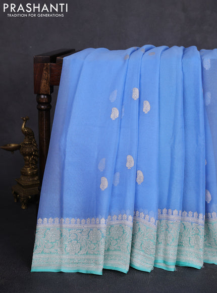 Banarasi chiffon saree teal blue and teal green with allover silver zari woven paisley buttas and silver zari woven floral border