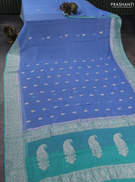 Banarasi chiffon saree teal blue and teal green with allover silver zari woven paisley buttas and silver zari woven floral border