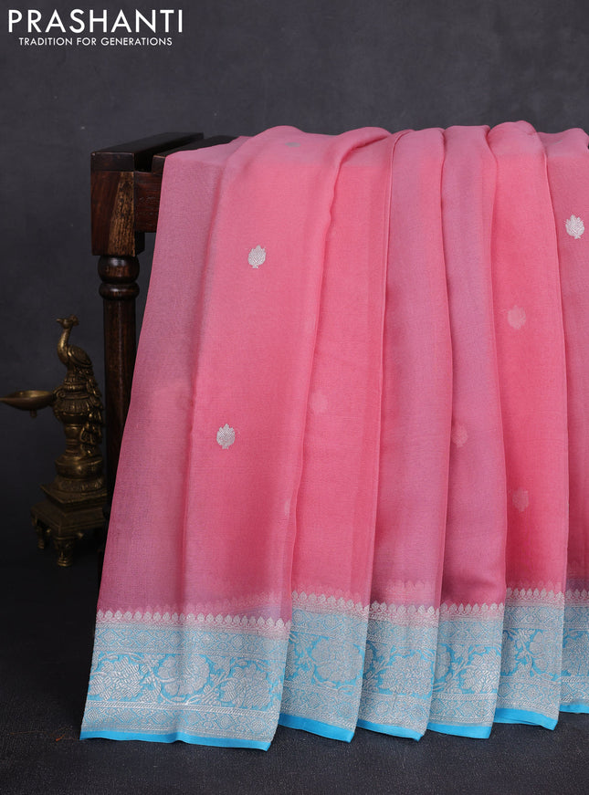 Banarasi chiffon saree peach pink and teal blue with allover silver zari woven buttas and silver zari woven floral border