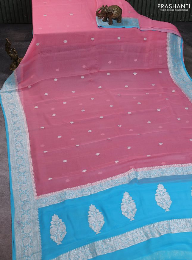 Banarasi chiffon saree peach pink and teal blue with allover silver zari woven buttas and silver zari woven floral border