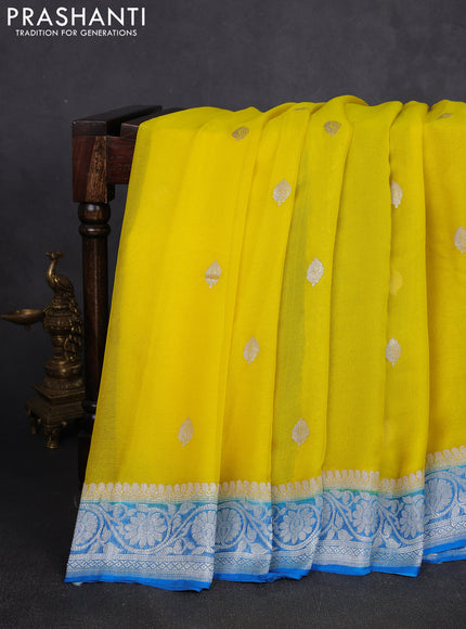 Banarasi chiffon saree yellow and cs blue with allover silver zari woven buttas and silver zari woven floral border