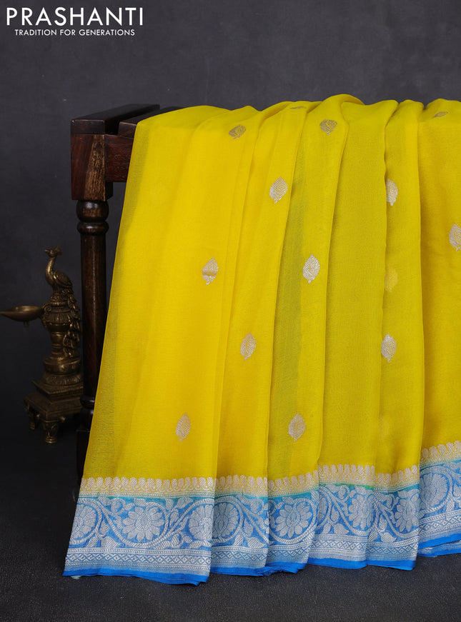 Banarasi chiffon saree yellow and cs blue with allover silver zari woven buttas and silver zari woven floral border
