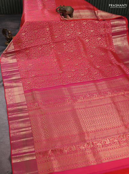 Pure kanchipuram silk saree dual shade of pinkish orange with allover zari woven brocade weaves and rich zari woven border