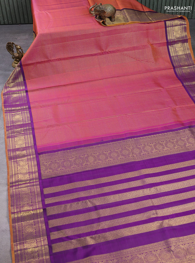 Pure kanchipuram silk saree dual shade of rustic orange and purple with allover zari woven checked pattern and rich zari woven border