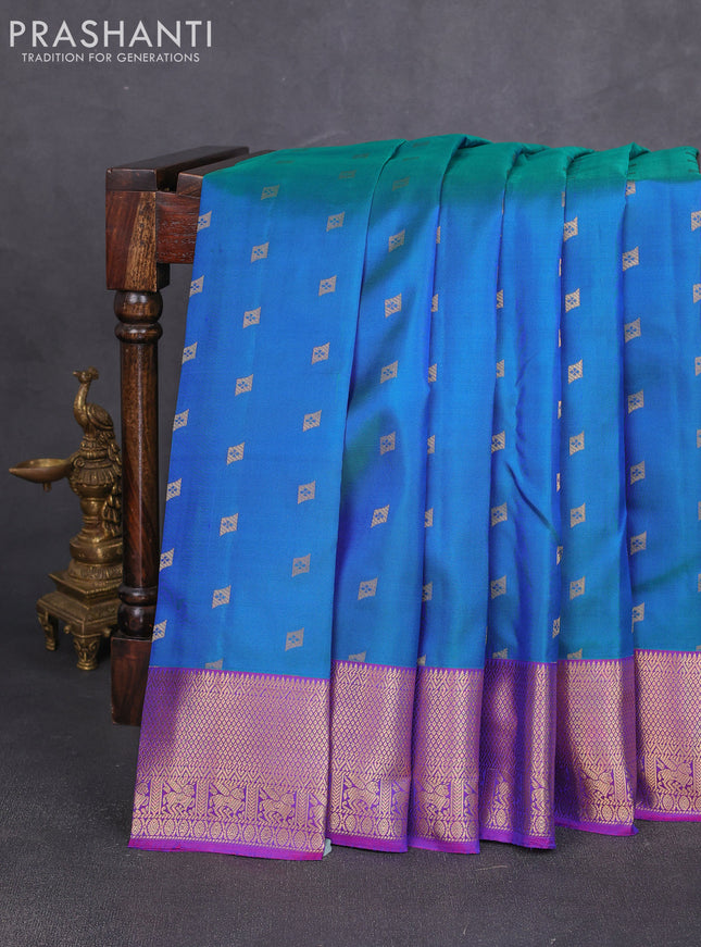 Pure kanchipuram silk saree dual shade of bluish green and purple with allover zari woven 1000 buttas and rettapet zari woven border