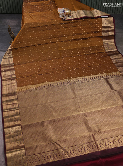 Pure kanchipuram silk saree dark mustard and coffee brown with allover zari woven 1000 buttas and zari woven korvai border