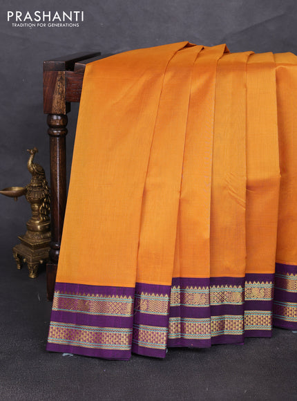 Silk cotton saree mustard yellow and purple with plain body and rettapet zari woven korvai border