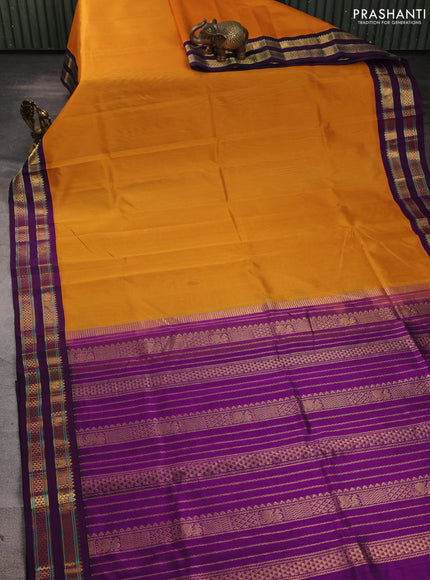 Silk cotton saree mustard yellow and purple with plain body and rettapet zari woven korvai border