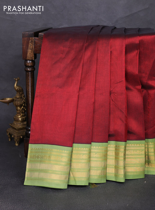 Silk cotton saree maroon and light green with plain body and zari woven korvai border