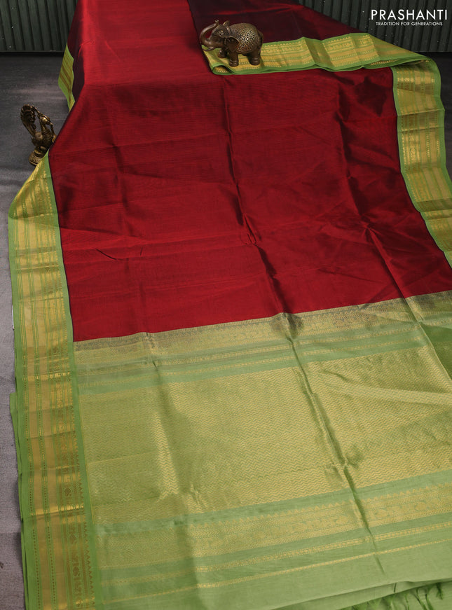 Silk cotton saree maroon and light green with plain body and zari woven korvai border