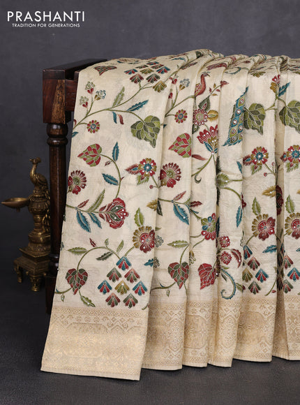 Crepe silk saree cream with allover prints & pita embroidery work and zari woven border