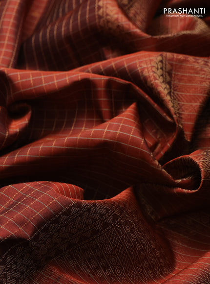 Pure soft silk saree rust shade with allover zari checks & buttas and zari woven border