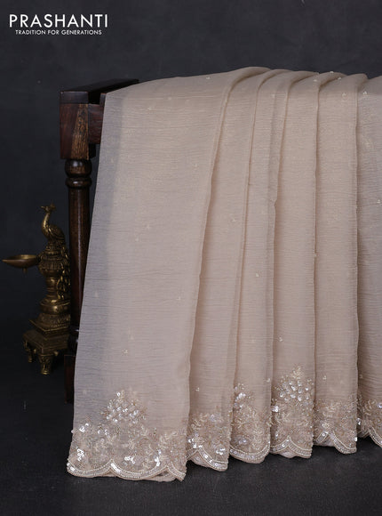 Crush tissue saree beige with beaded work buttas and sequin & beaded embroidery pallu & border