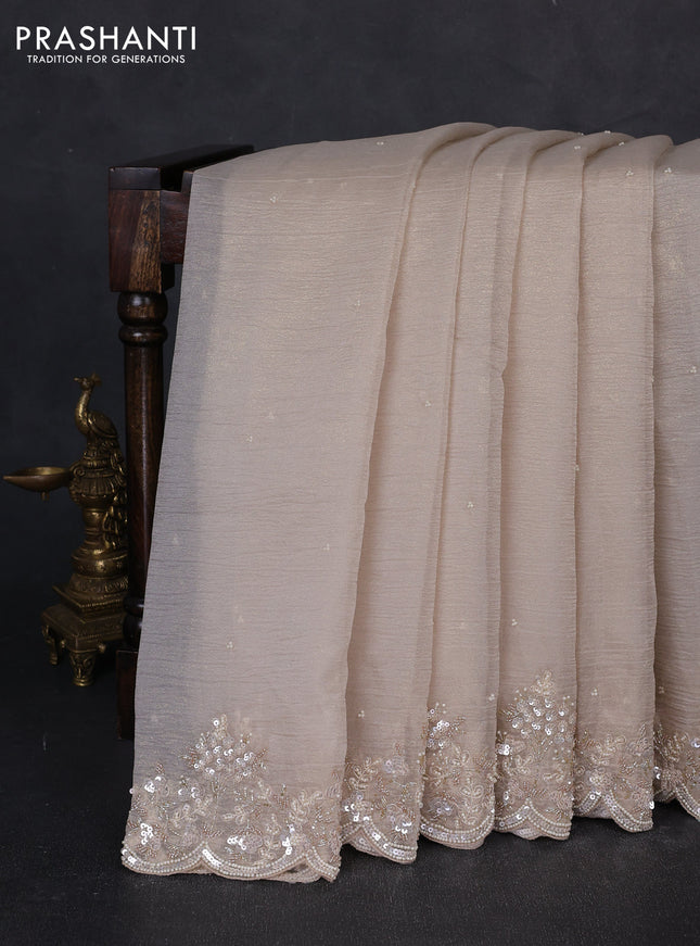 Crush tissue saree beige with beaded work buttas and sequin & beaded embroidery pallu & border