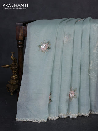 Crush tissue saree teal blue with floral sequin embroidery buttas and beaded work border