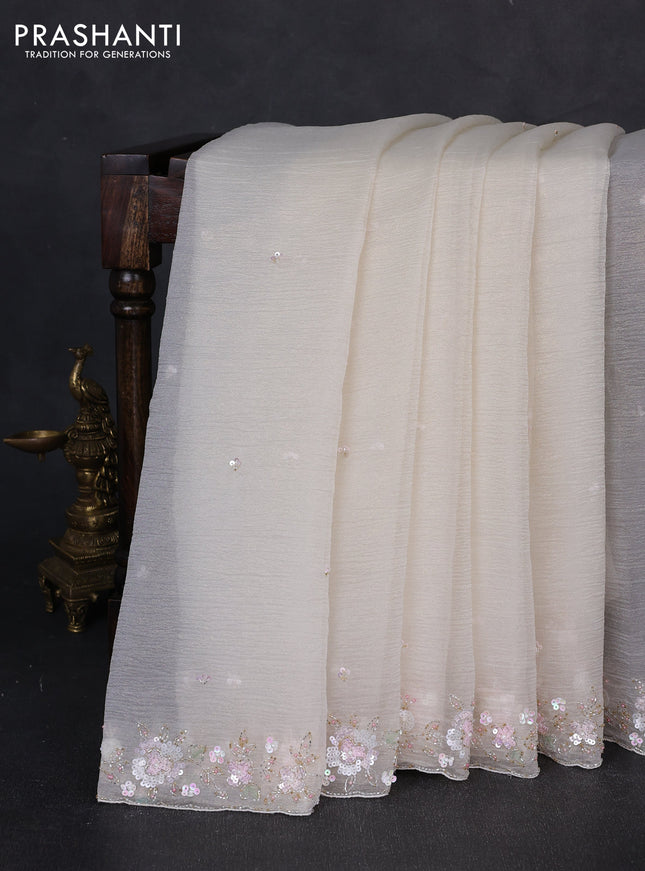 Crush tissue saree cream with sequin embroidery buttas and floral sequin embroidery pallu & border