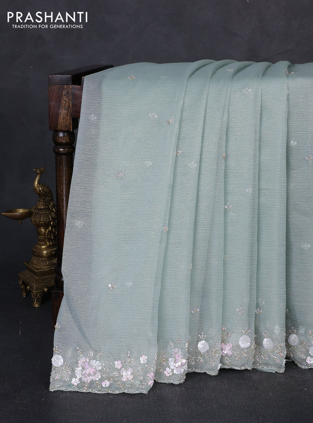 Crush tissue saree pastel green with sequin embroidery buttas and floral sequin embroidery pallu & border