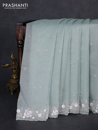 Crush tissue saree pastel green with sequin embroidery buttas and floral sequin embroidery pallu & border