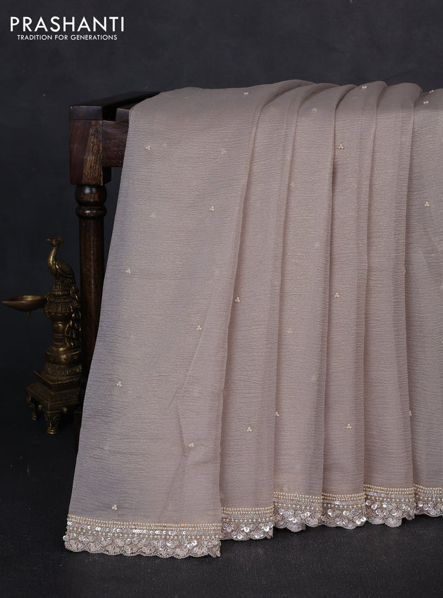 Crush tissue saree beige with beaded work buttas and sequin embroidery pallu & border