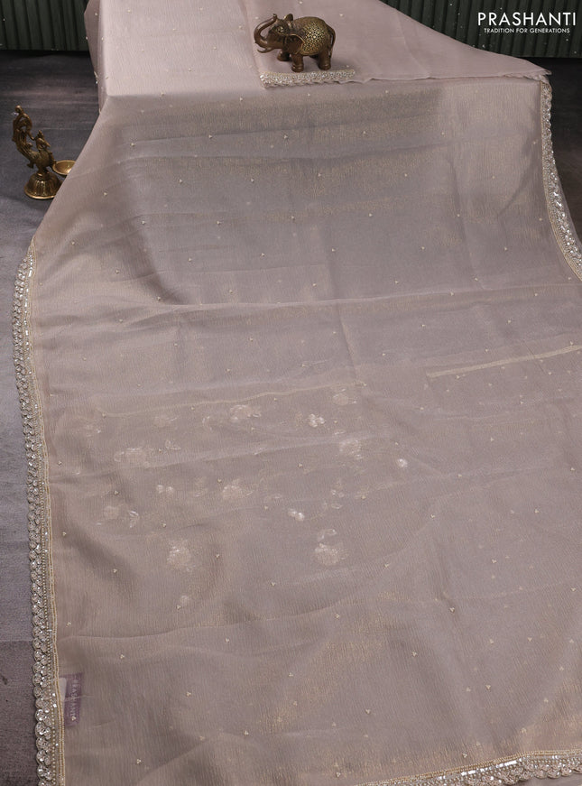 Crush tissue saree beige with beaded work buttas and sequin embroidery pallu & border