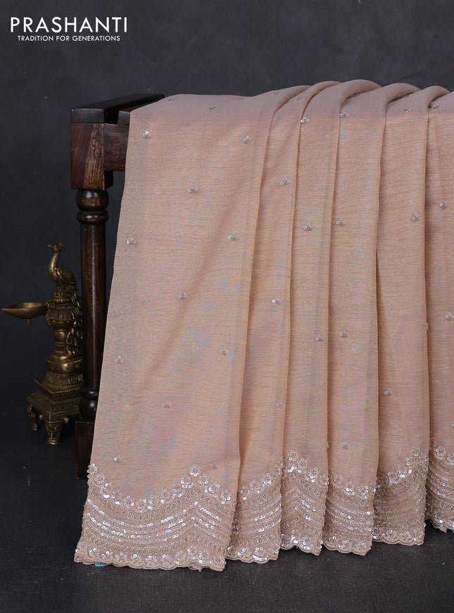 Crush tissue saree pastel peach with sequin embroidery buttas and sequin embroidery pallu & border