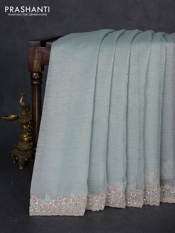 Crush tissue saree pastel green shade with allover stone work and sequin embroidery pallu & border