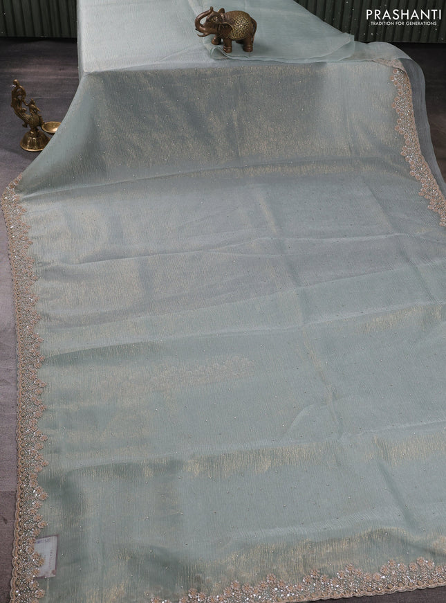 Crush tissue saree pastel green shade with allover stone work and sequin embroidery pallu & border