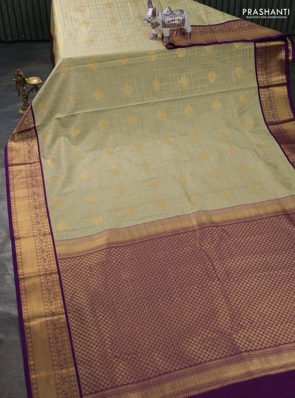 Semi kanchipuram silk saree mild pista green and purple with allover zari checks & buttas and zari woven korvai border